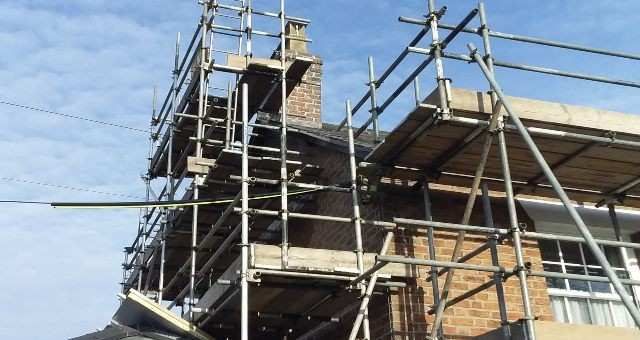 Construction on a tall face brick building