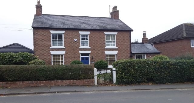 image of a face brick house with a front yard