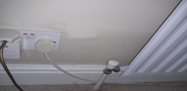 Rising damp tide marks on lower walls showing peeling paint and salt efflorescence