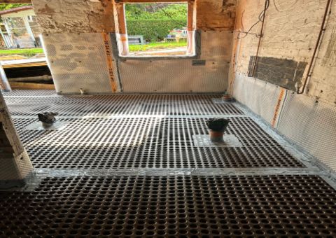 Structural waterproofing is a common technique used to prevent lateral penetrating damp from high ground levels, diverting the moisture away through a drainage system
