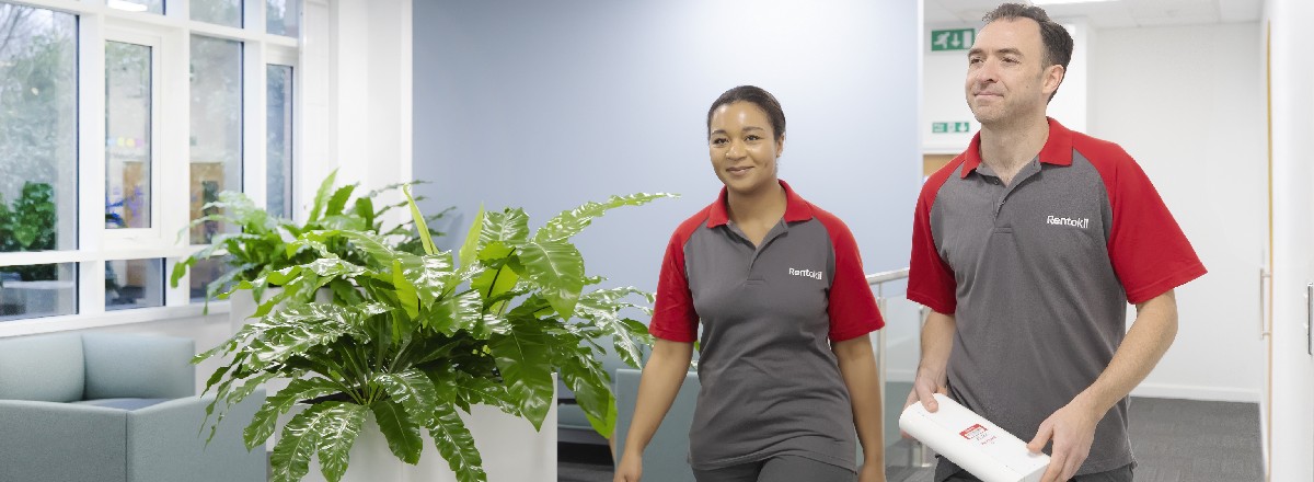 2 Rentokil pest controllers in a business office area