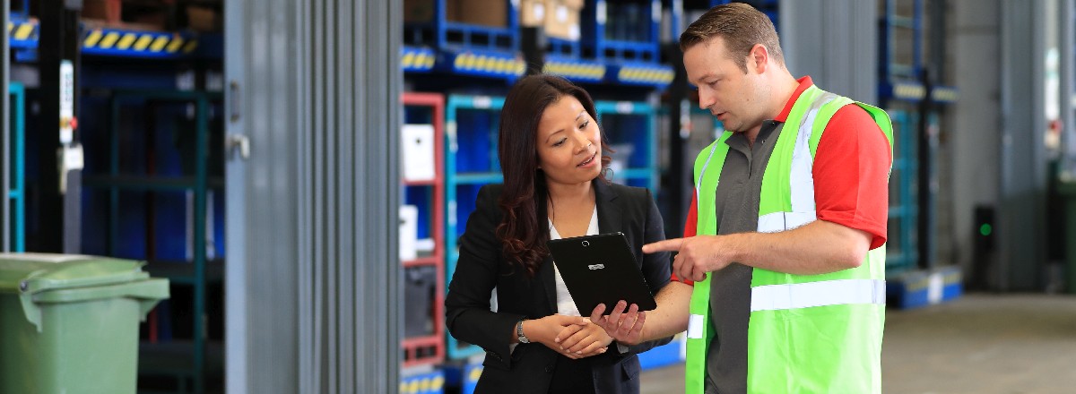 Rentokil pest controller with business customer in warehouse