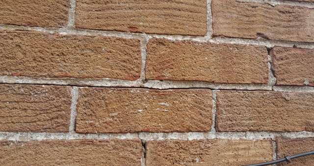 Horizontal cracks along the mortar joints are often the first sign of failing wall ties. The rusting ties expand, forcing the bricks apart.