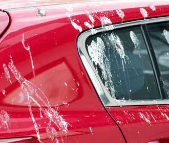 Bird droppings on a red car